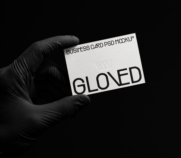 Gloved Hand Holding Business Card Stationery PSD Mockup